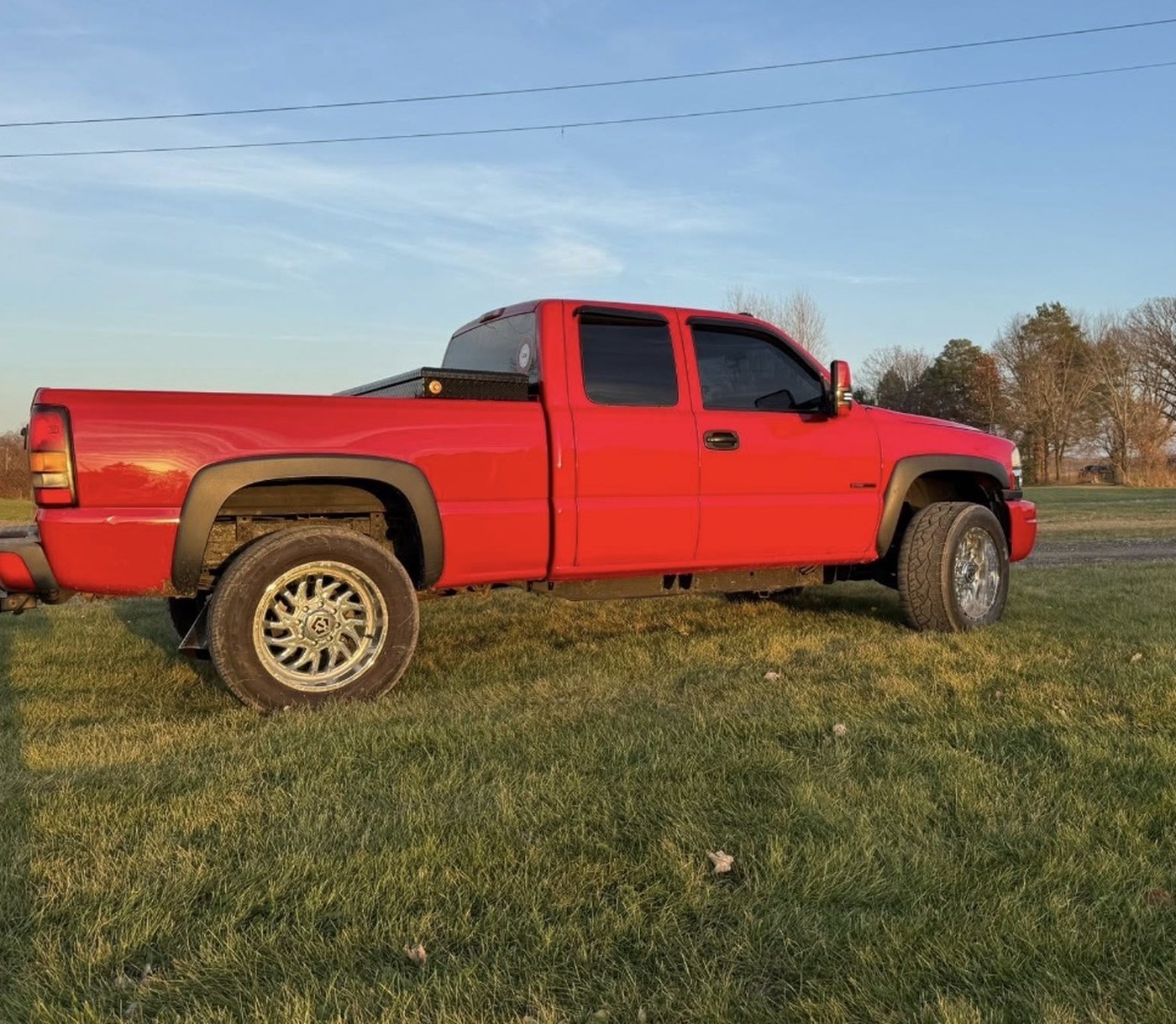 Red extended-cab truck with chrome wheels